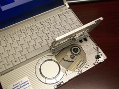 an open laptop computer sitting on top of a wooden desk