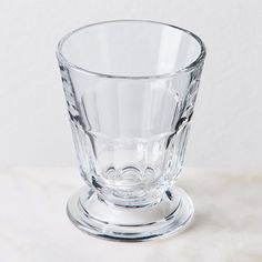 a clear glass cup sitting on top of a table