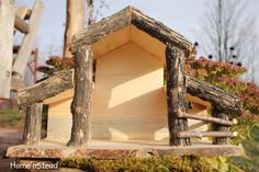 a bird house made out of wood and logs