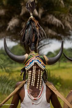 a man with horns and beads on his head