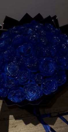 a large blue flower arrangement sitting on top of a table