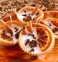 three orange slices are sitting on top of some cupcakes