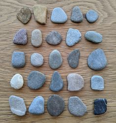 several rocks arranged in a circle on a wooden surface