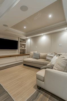 a large living room with couches and a flat screen tv on the far wall