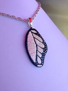 a necklace with a butterfly wing on it