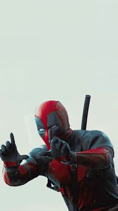 the deadpool character is holding his hands up in front of him and pointing at something