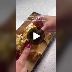 a person is cutting up food on a wooden board