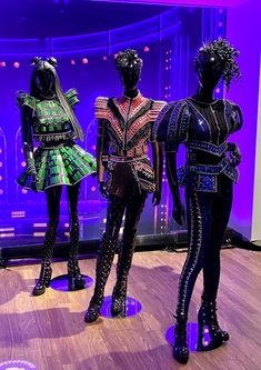 three mannequins dressed in brightly colored clothing