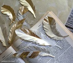 some gold leaves on top of an open book