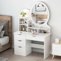 a bedroom with a white vanity and mirror