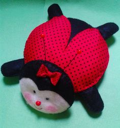 a stuffed animal with a red bow on it's head sitting on a green surface