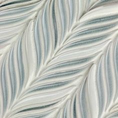 an abstract pattern made up of white and blue stripes on a wallpapered surface