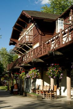 the outside of a building with flowers hanging from it's balconies