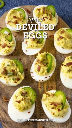 deviled eggs with bacon and jalapenos on a wooden platter that says spicy deviled eggs