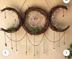 a wall hanging made out of branches and beads