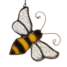 a stained glass bee ornament hanging from a hook