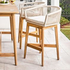 an outdoor table with chairs and fruit on it