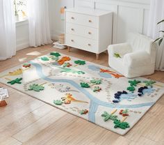 a child's rug with animals and trees on it in a white room next to a dresser