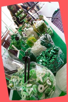 a table filled with lots of green and white candies