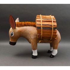 a wooden toy horse with a basket on its back