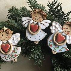 three christmas ornaments hanging from a tree