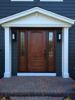 a black house with a brown front door