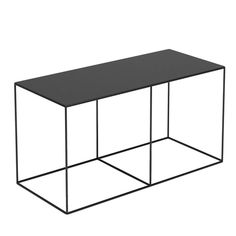 a black table sitting on top of a white floor