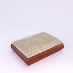 a wooden box with a metal cover on it's sides and a white background