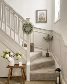 there is a vase with flowers on the stairs