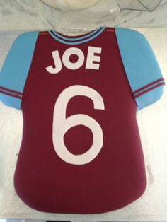 a cake shaped like a soccer jersey with the number six on it's chest