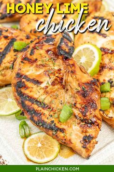 grilled chicken on a plate with limes and lemon wedges for garnish