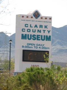 a sign for clark county museum in front of mountains