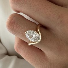 a woman's hand with a diamond ring on it