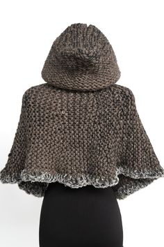 a woman's brown knitted cape on top of a mannequin head