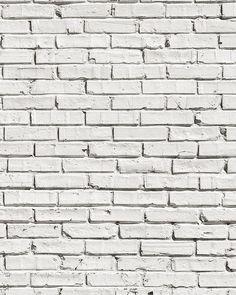 an old white brick wall with no mortar