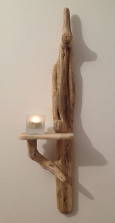 a wooden shelf with a candle on it