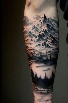 a man's leg with mountains and trees on it