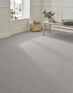 a bedroom with grey carpet and white walls