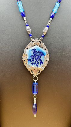 I bought this rare nearly 100 year old piece of art deco era glass and created a custom mount for him in silver tone filigree. I added glass beads, two sterling beads, and a dangle and made a custom chain. He's devine and one of a kind!  Wearable length: 19" Piece including dangles: 5" NOTE: All my pieces are up upcycled, artisan made one of a kind. My vintage and antique pieces offered for sale have been preloved. Some pieces are nearly 100 years old! With age, pieces lose color and show wear; Blue Vintage Crystal Necklaces, Art Deco Blue Pendant Necklace, Ornate Blue Pendant Necklace, Art Deco Multi-stone Sapphire Jewelry, Vintage Glass Birds Necklace, Custom Wraps, Art Deco Era, Glass Birds, Silver Tone