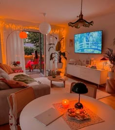 a living room filled with furniture and a flat screen tv mounted to the side of a wall