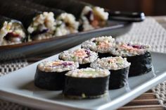 sushi is served on a plate with chopsticks