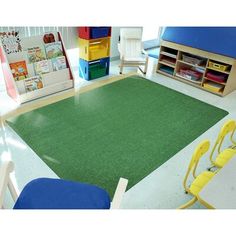 a classroom with chairs, desks and an area rug for children to sit on