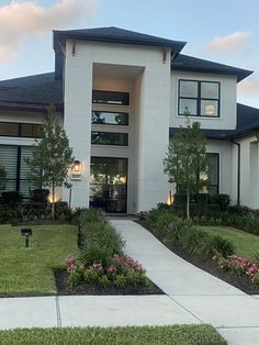 a large white house with landscaping around it