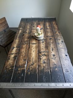 a wooden table with two chairs around it