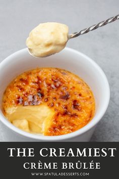 the creme brulee is served in a white bowl with a spoon