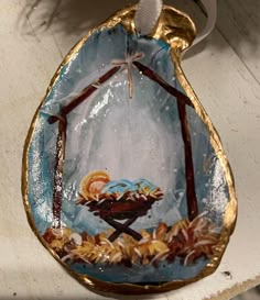 an ornament hanging from the side of a wall with a nativity scene on it