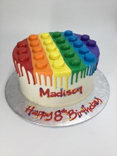 a birthday cake decorated with legos and the name madison on it's icing