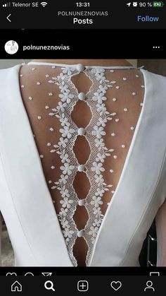 the back of a woman's dress with white lace on it