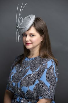 Luminous metallic silver sinamay straw button fascinator. Trimmed in metallic silver hemp straw braid and white tipped, floating, metallic silver arrow feathers. Light and easy to wear Features a comb and elastic attachment for comfortable all day wear. Lifted Millinery headwear is constructed with time honored techniques and fine craftsmanship. All hats are meticulously blocked and sewn by hand without the use of adhesives to attach trims. This ensures a long lasting hat with the ability to be Luxury White Formal Fascinator, English Hats, White Fascinator, Arrow Feather, Sinamay Hats, Silver Arrow, Kentucky Derby Hats, White Tip, Hat Box