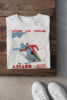 Keywords: UNISEX Vintage Skiing T-Shirt | Ski Lover Hoodie | Skier Sweatshirt, Winter Sports Tee, Asiago Italy Top, Snow Mountain Shirt, Snowboarding Dad Gift Snowboard shirt Ski sweater skier accessories ------------------------------------------------ QUALITY This T-shirt is a UNISEX t-shirt with a vintage illustration and it feels soft and light, with just the right amount of stretch. It features a crew neck, pre-shrunk fabric and side-seamed fit. FIND YOUR SIZE Please find the fitting guide in the pictures to determine your size. Pro Tip: Choose the best size by comparing the measurements of your favorite T-Shirt with the ones listed on the chart. SHIPPING We work with a reliable, high-quality print-on-demand partner with locations in US and the EU, so depending on the destination your Ski Graphic Tee, Ski Decorations, Ski Themed Party, Ski Lodge Aesthetic, Apres Ski Aesthetic, Snowboard Outfit, Lodge Aesthetic, Winter Graphics, Ski Shirt